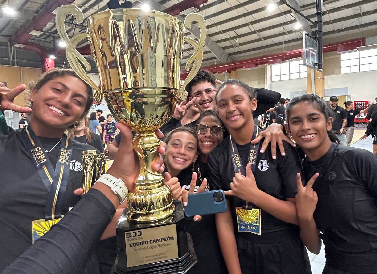 Alliance Puerto Rico team celebrating a team championship trophy