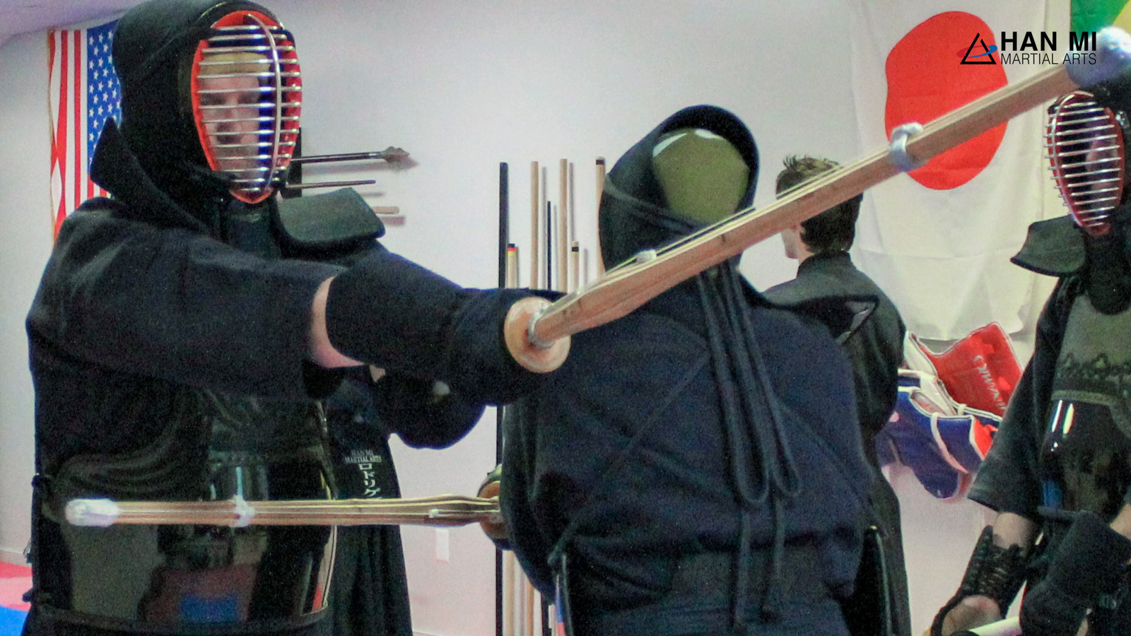 Two kendo students in armor crossing bamboo swords