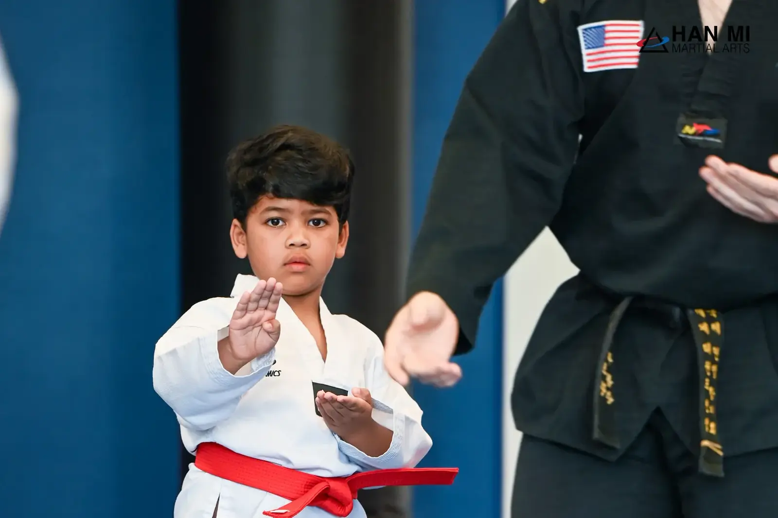 Young student in a focused stance with an instructor