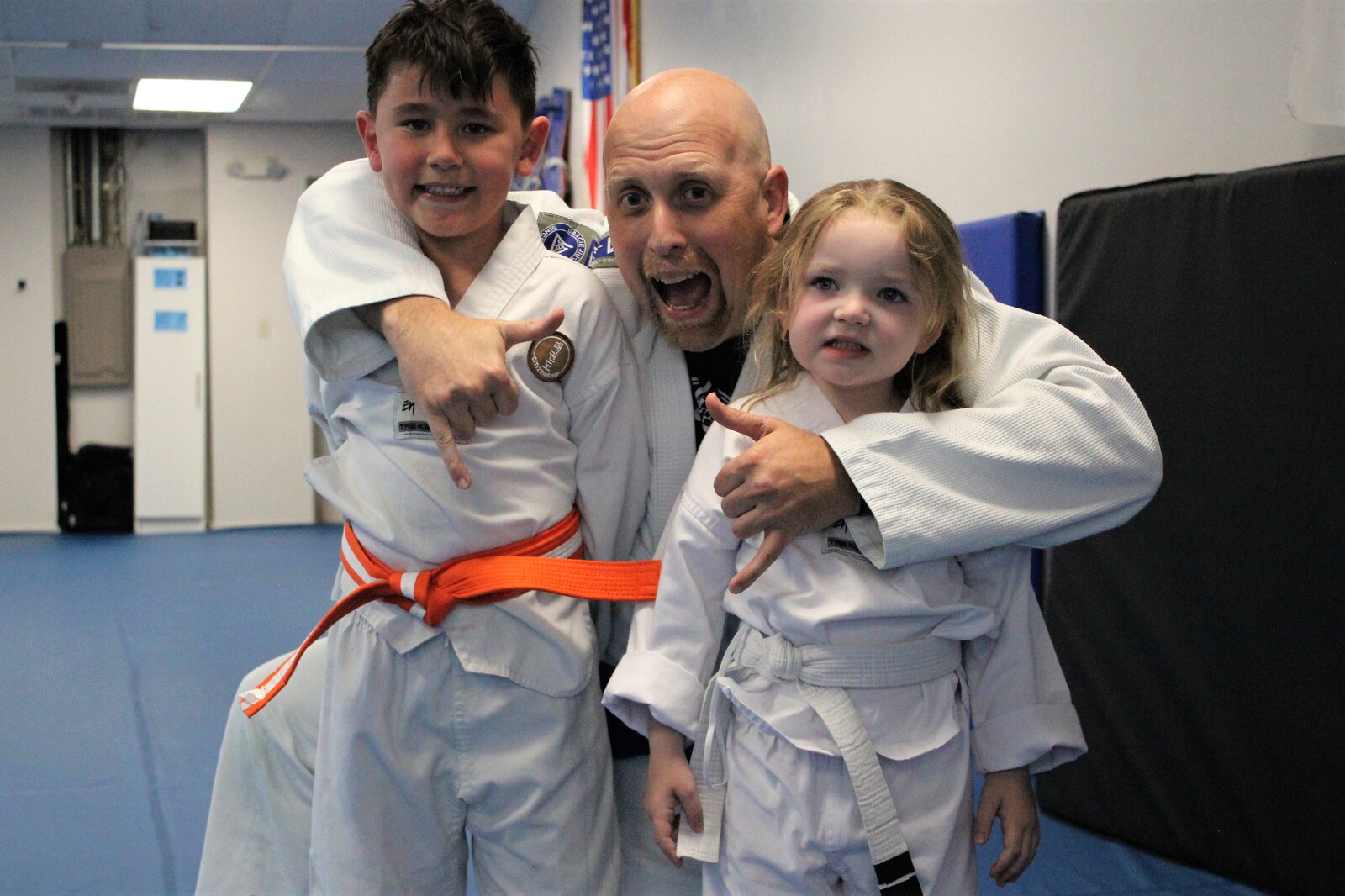 A coach with two smiling young students