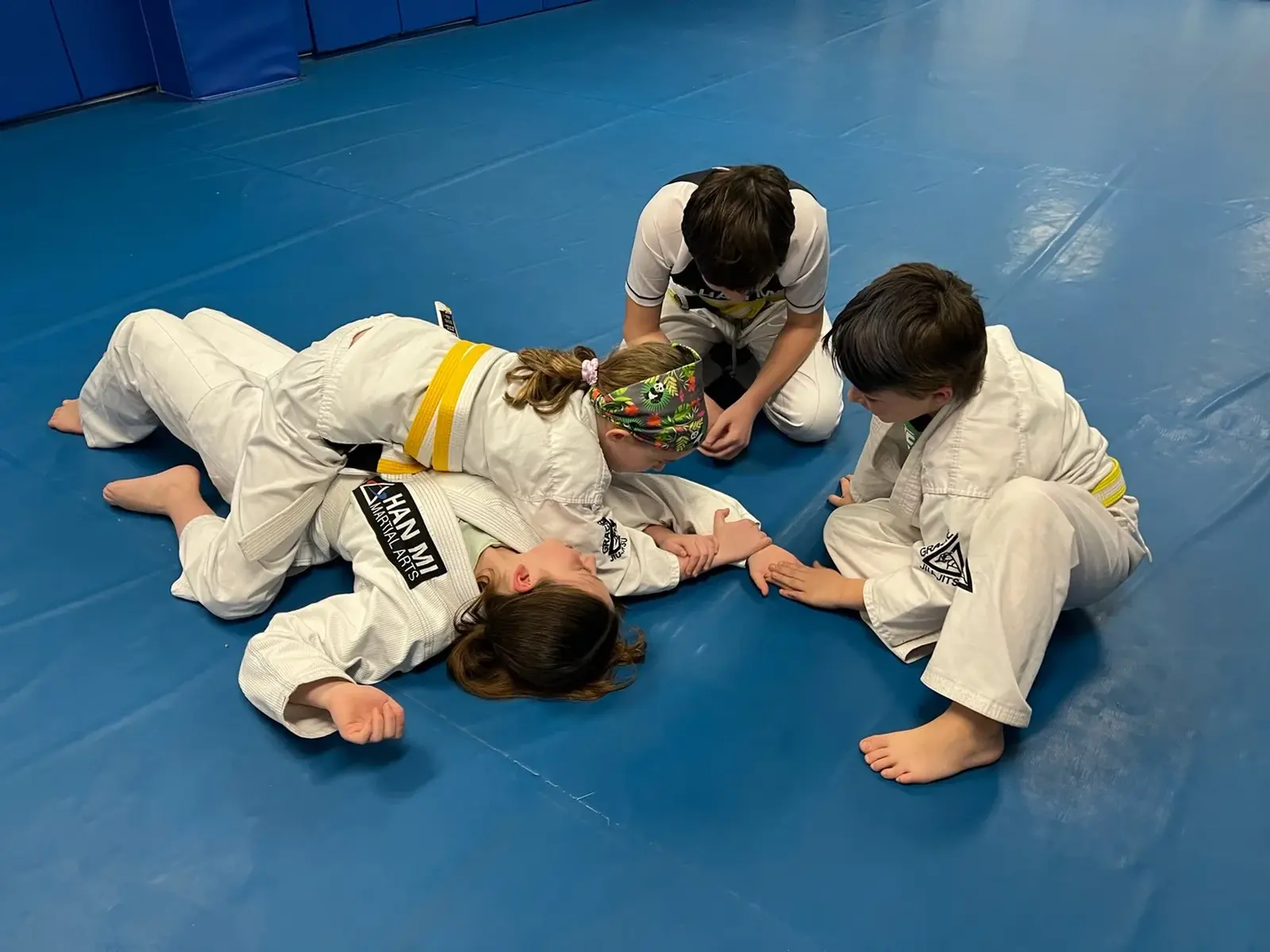 Youth Jiu-Jitsu students practicing a pin with partners