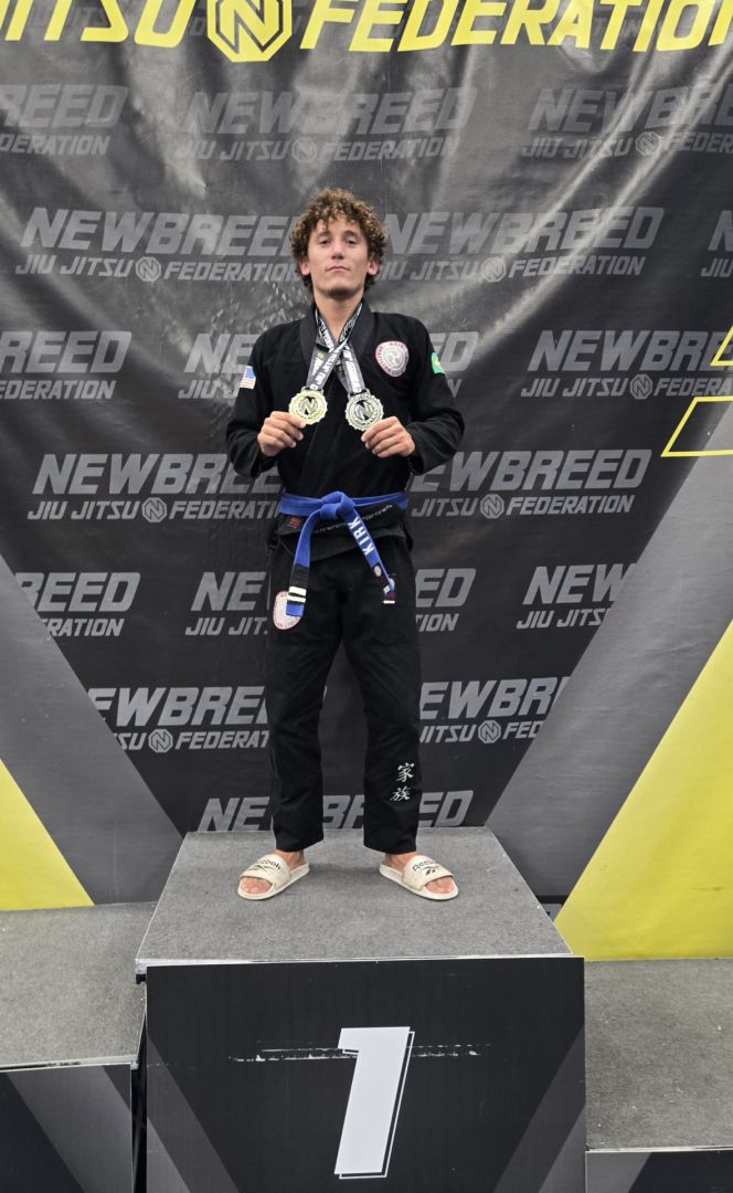 Axis competitor in first place on a NewBreed podium