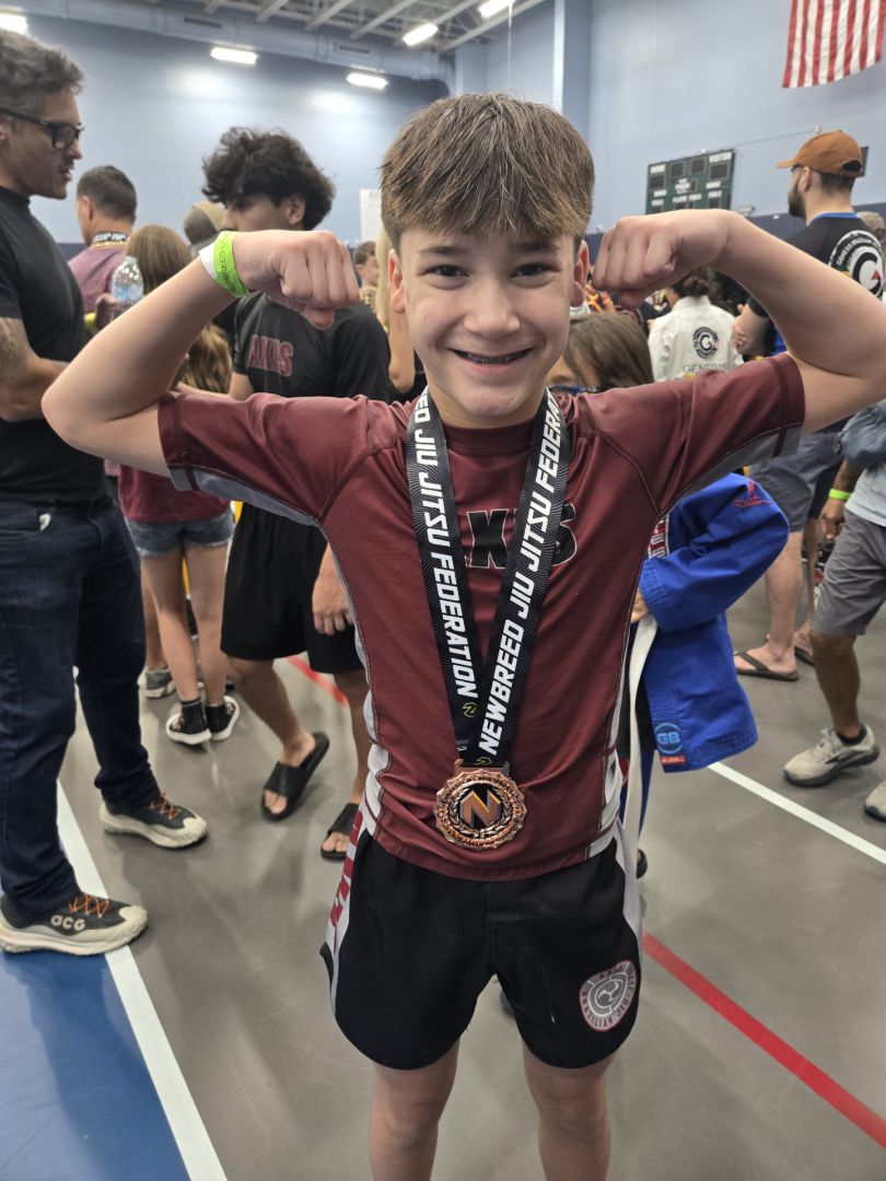 Axis kid showing off a tournament medal