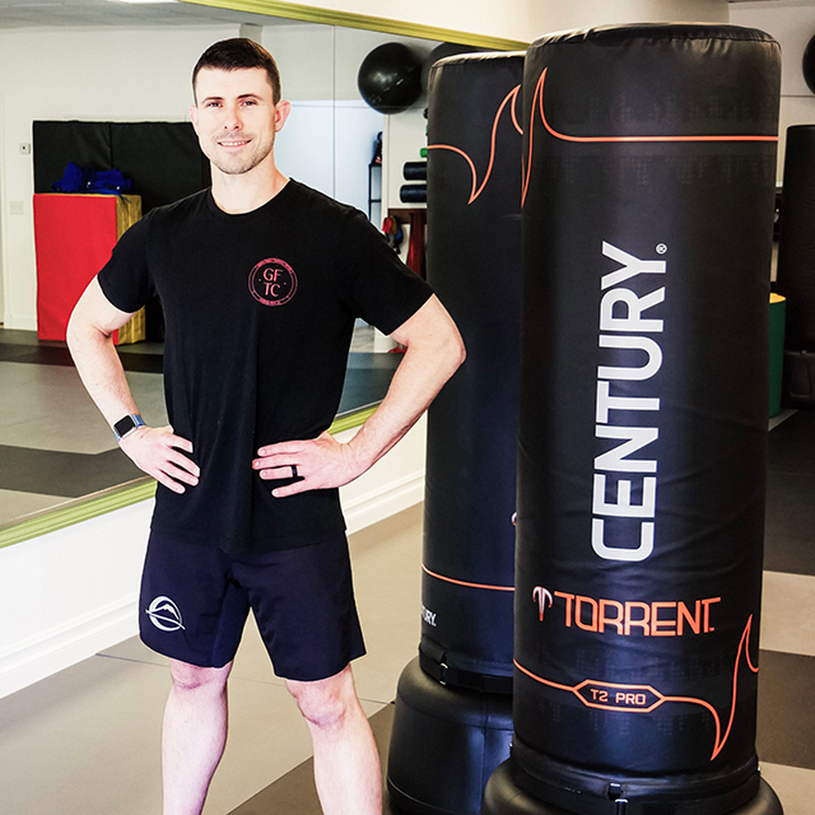 Instructor standing with Century training bags at Green Family Training Center.