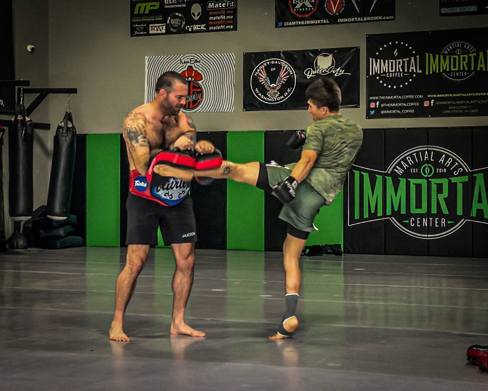 Two men practicing striking with pads