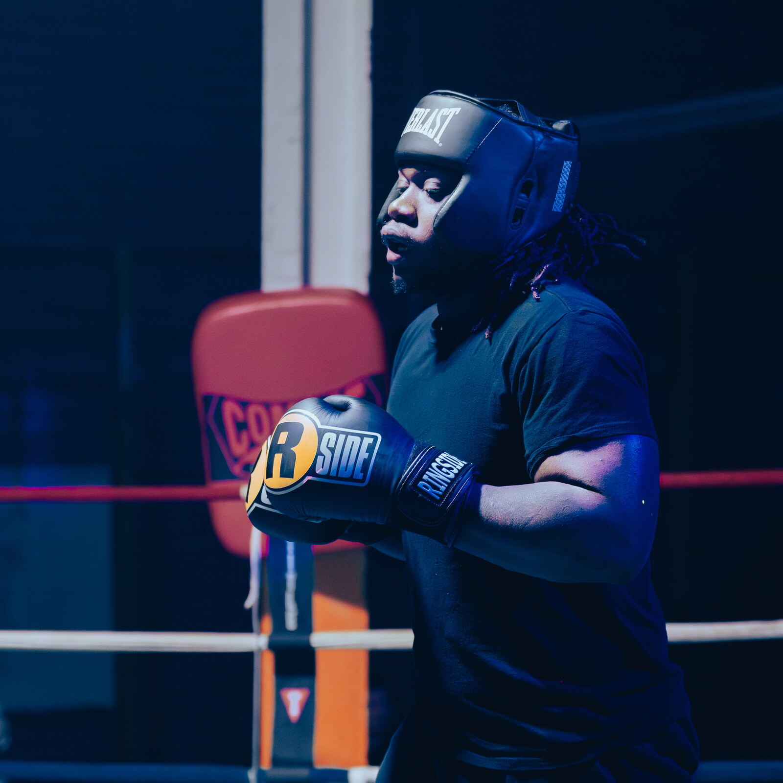 A boxer in headgear and gloves in the ring at The Sweat Lab in Gibsonville, NC