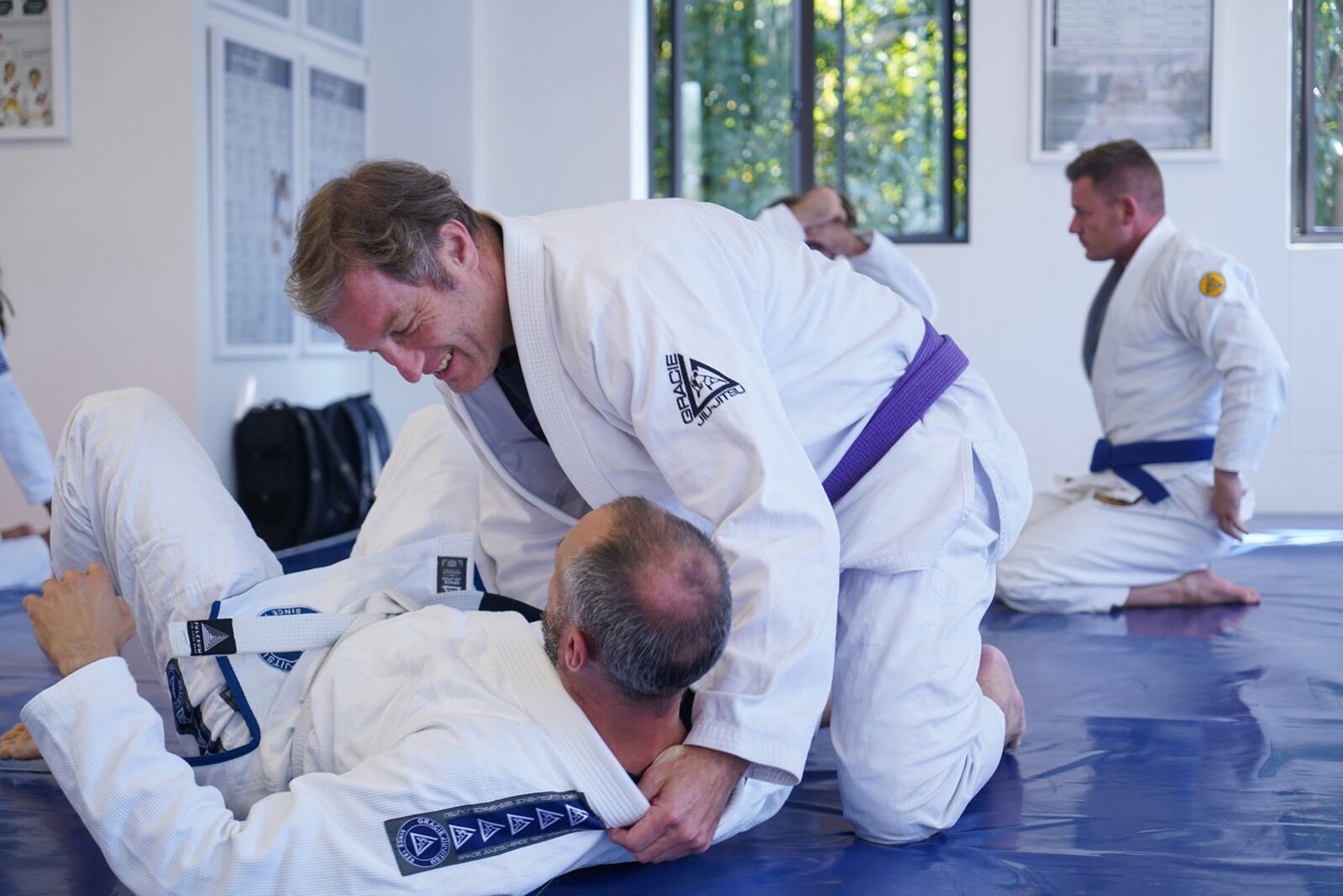 Adults in gis practising a Gracie Jiu-Jitsu technique on the mats at Gracie Jiu-Jitsu Fourways
