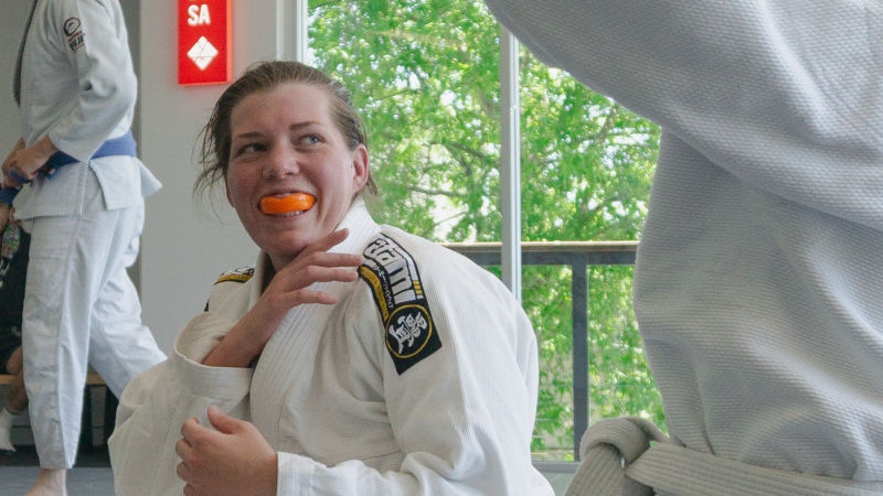 brazilian jiu jitsu student smiling during bjj martial arts class