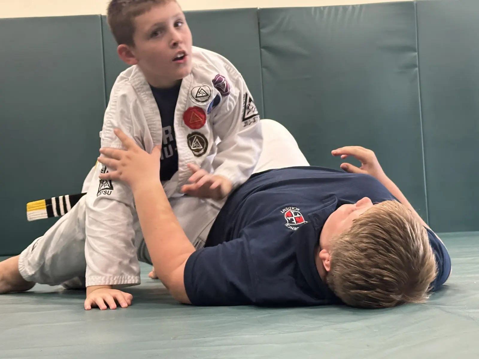 An instructor explaining a ground technique to a training partner