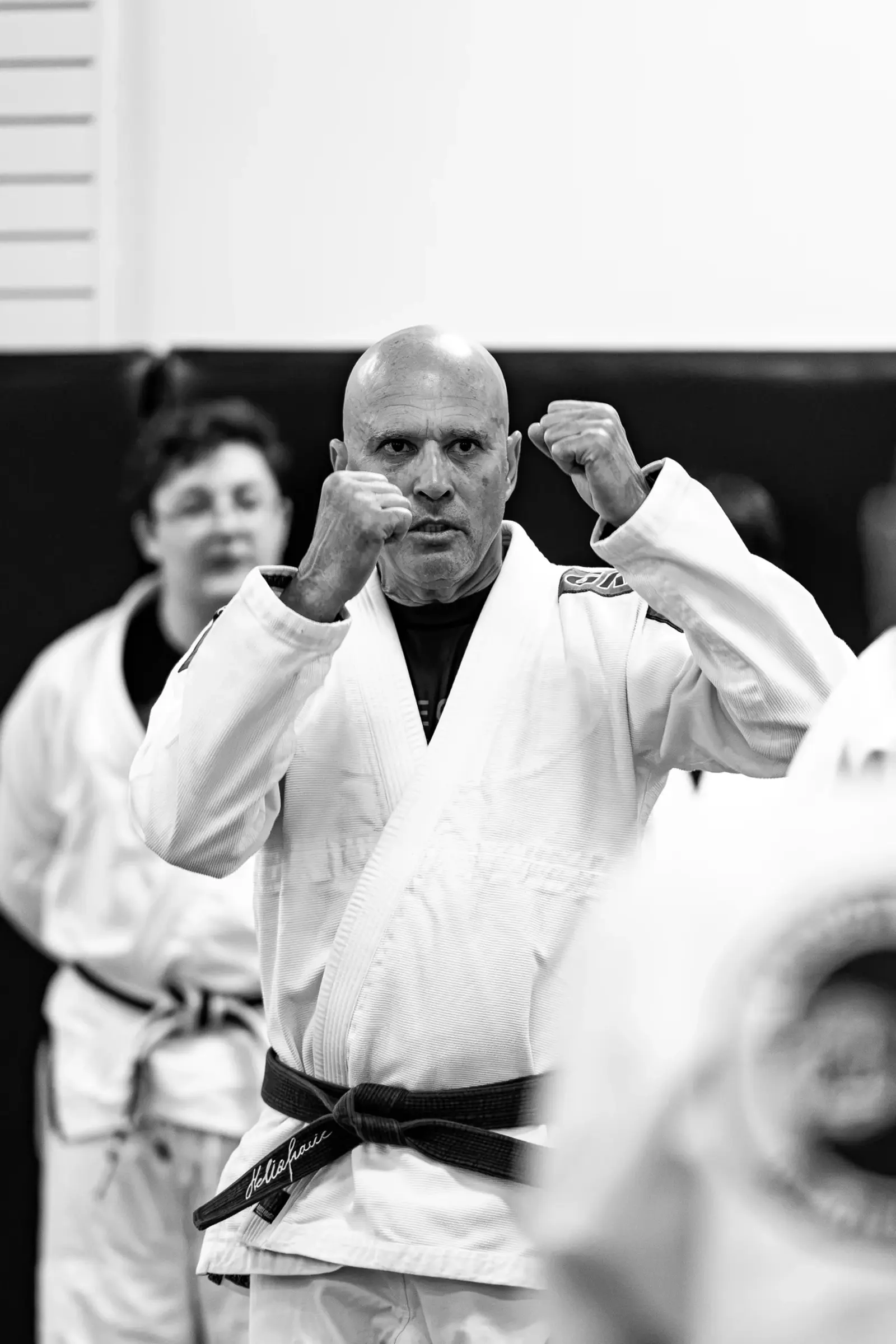 Jiu-jitsu practitioners at a seminar, photographed in black and white