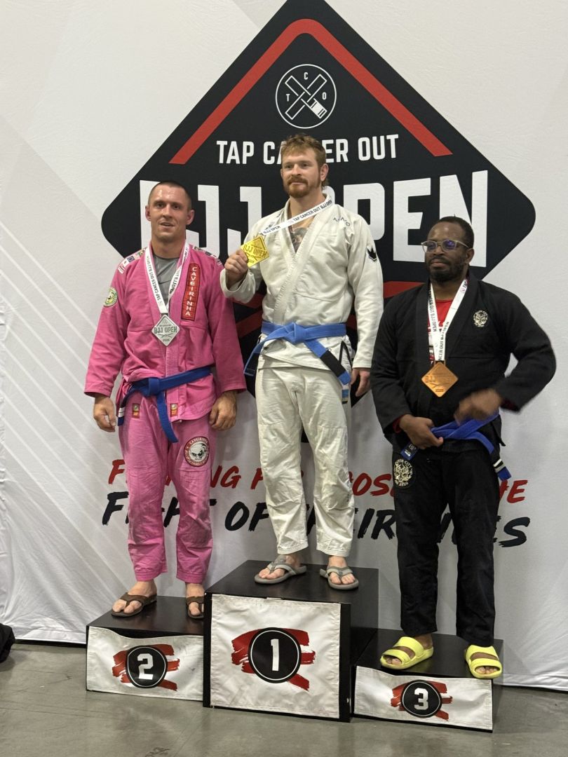CJJF competitors with medals on the Tap Cancer Out podium
