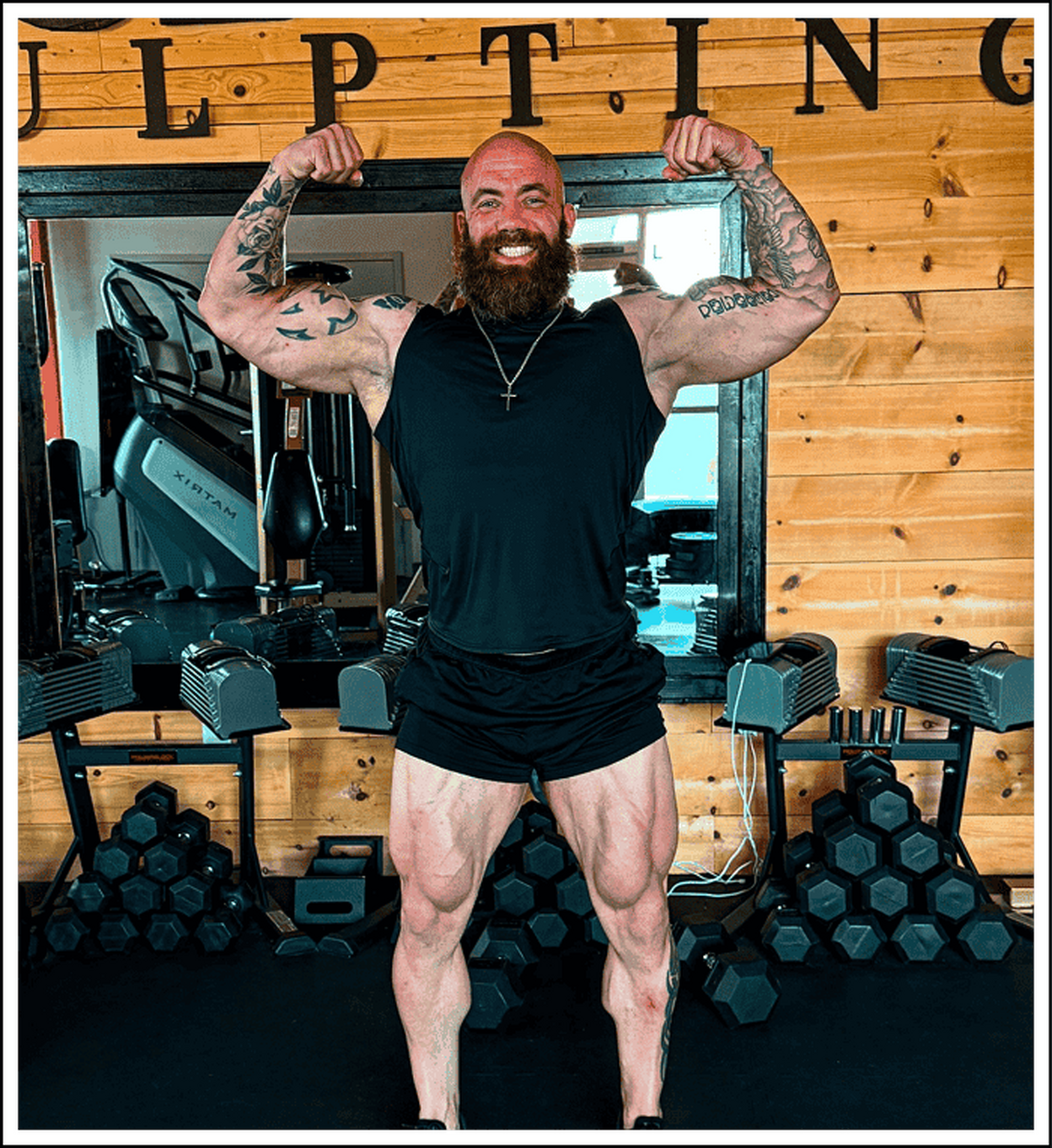 Dexter Henderson flexing in a gym