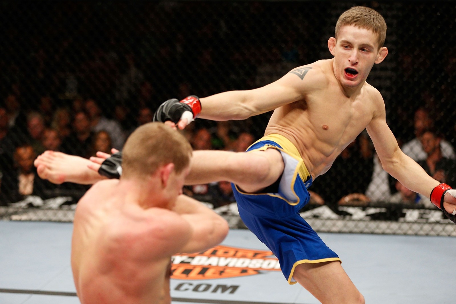 Chris Holdsworth throwing a kick during his professional MMA career