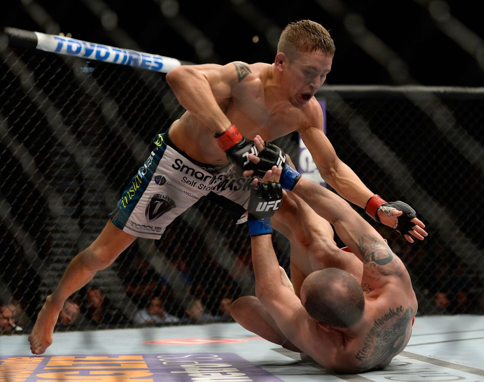 Chris Holdsworth competing in the UFC with his opponent on the mat