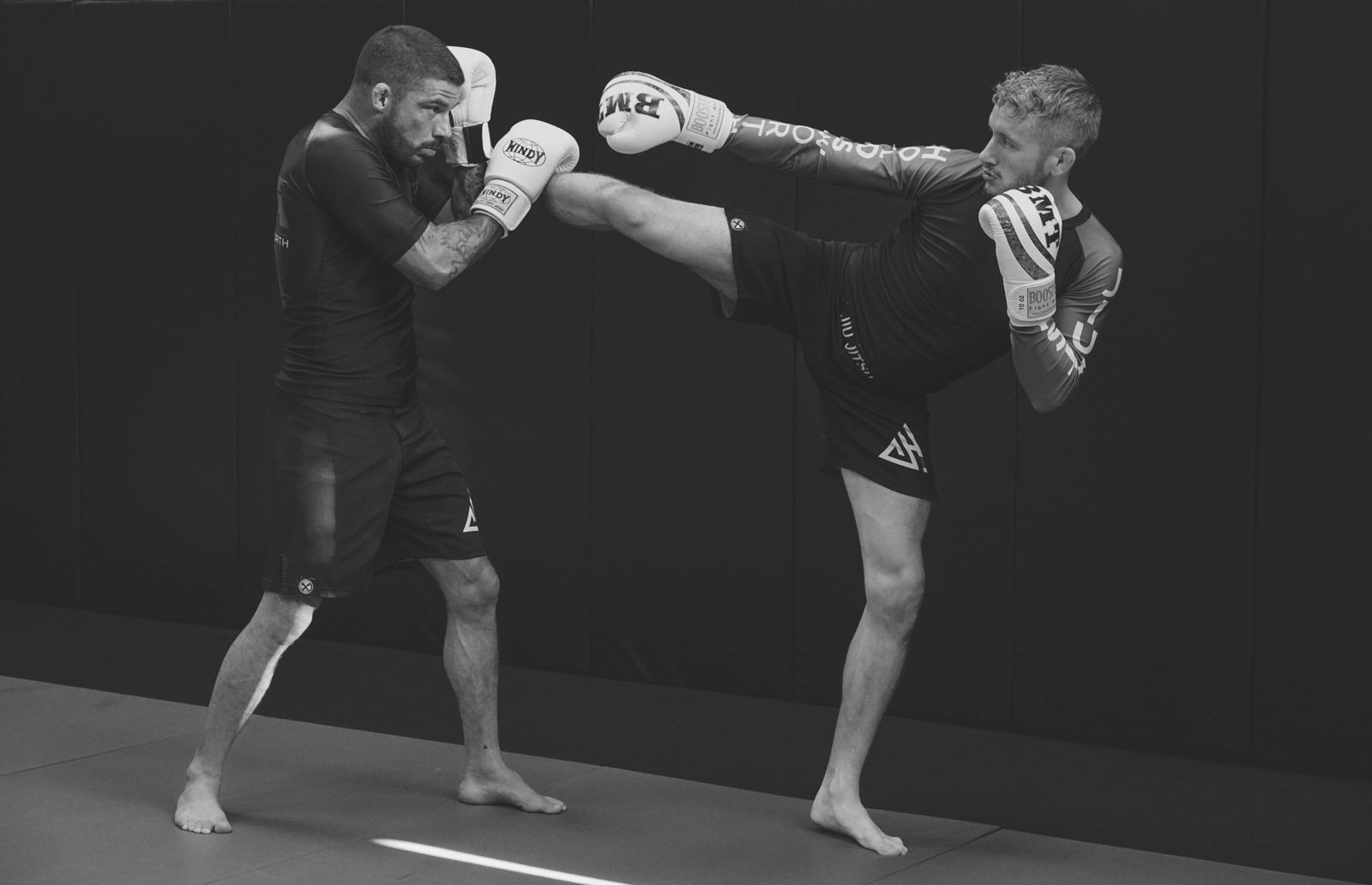 Chris Holdsworth throwing a high kick in kickboxing training