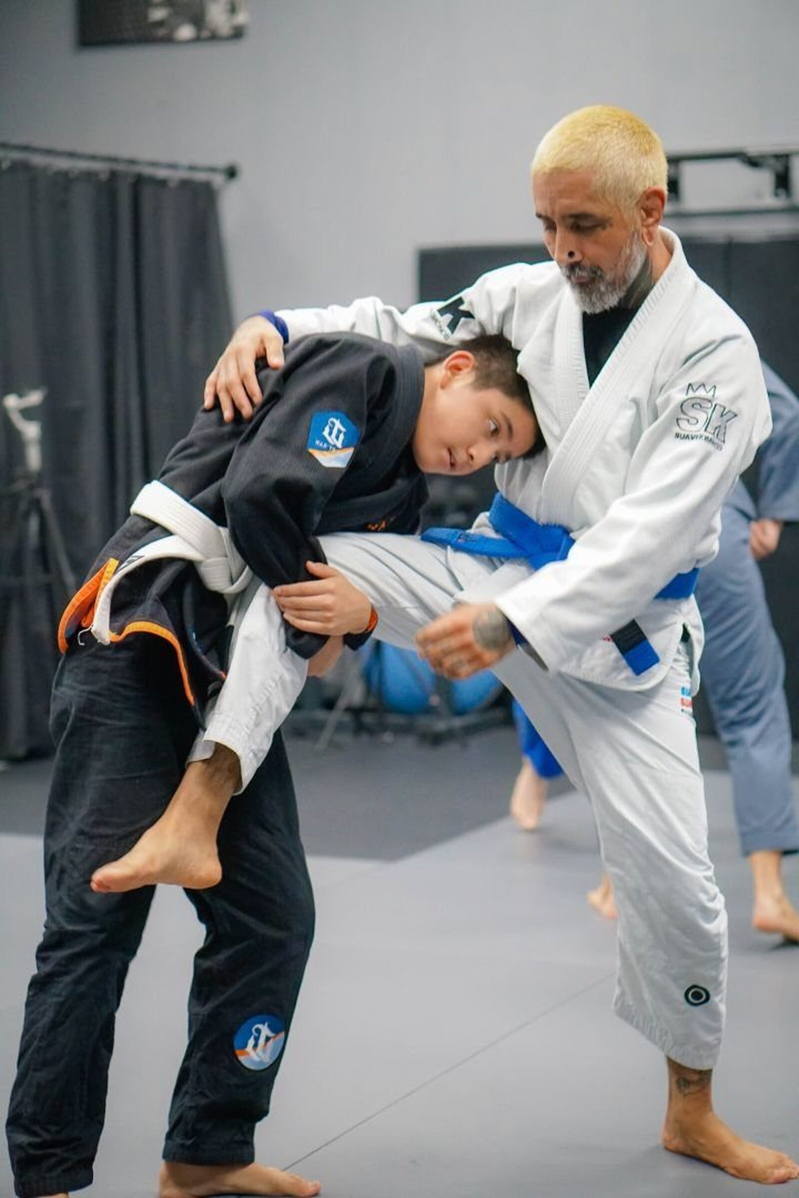 Coach showing a throw to a young student
