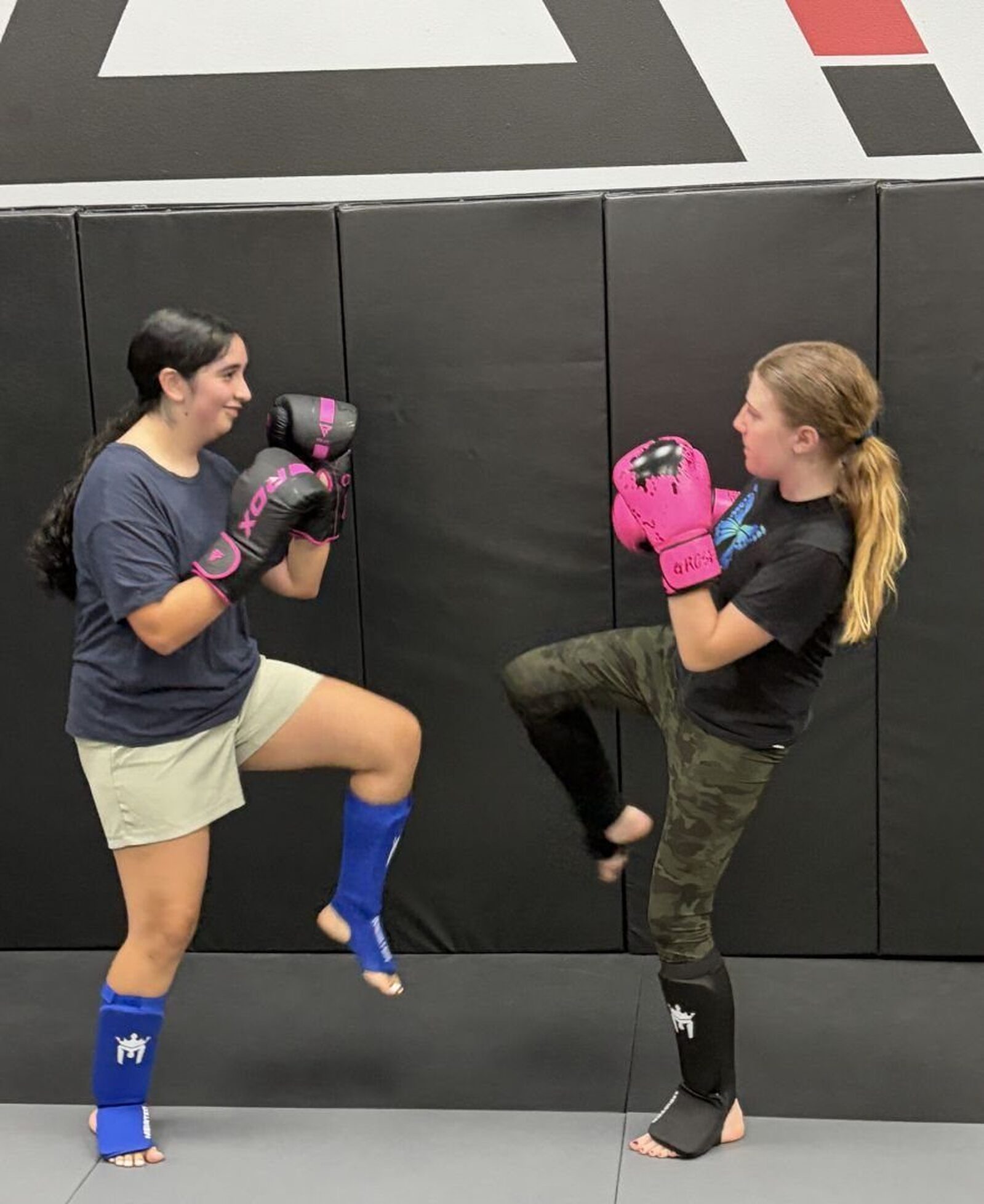 Two students practicing kickboxing technique