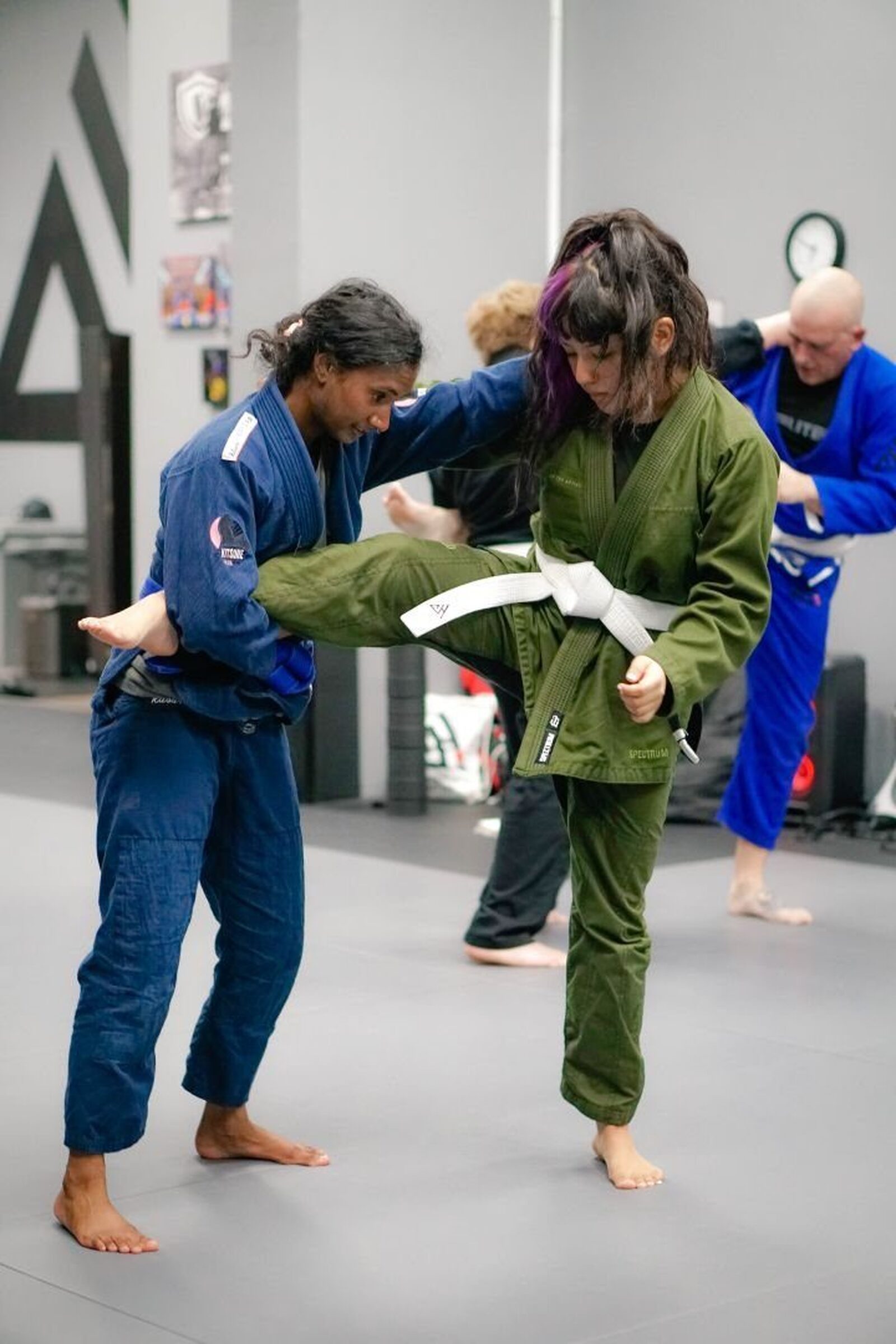 Two students drilling a single-leg defense in gis