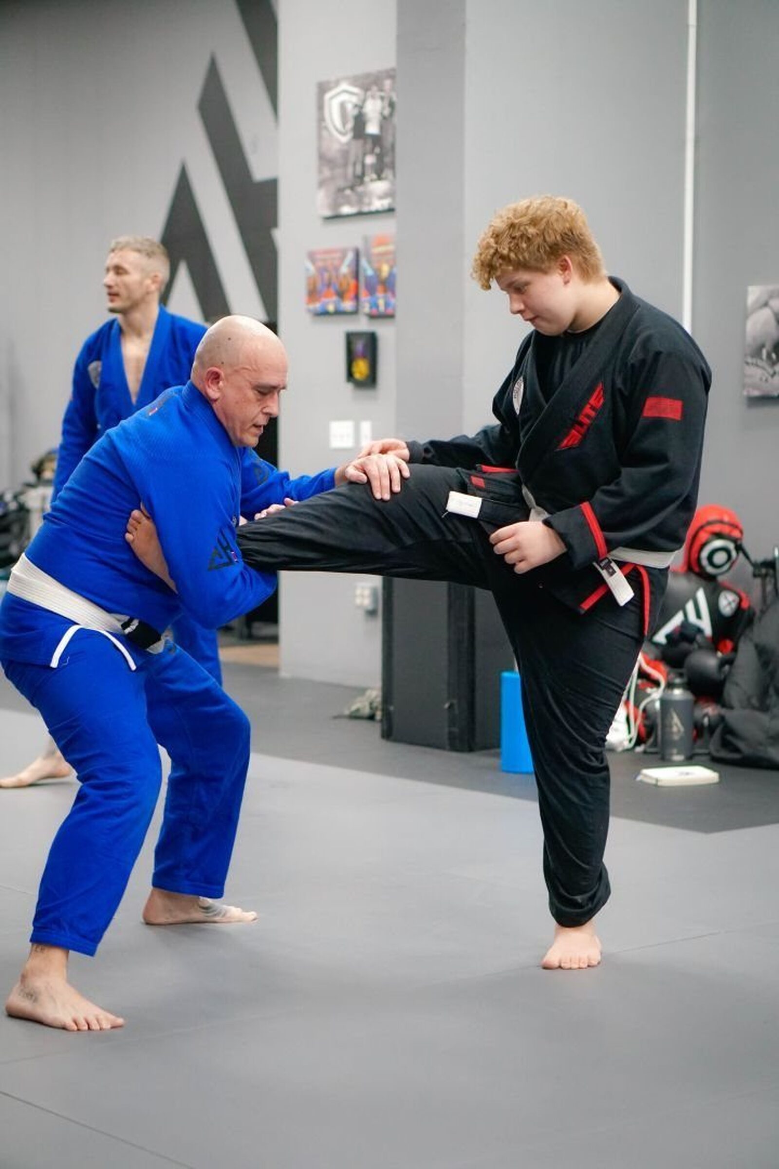 Teen student drilling a kick with a coach