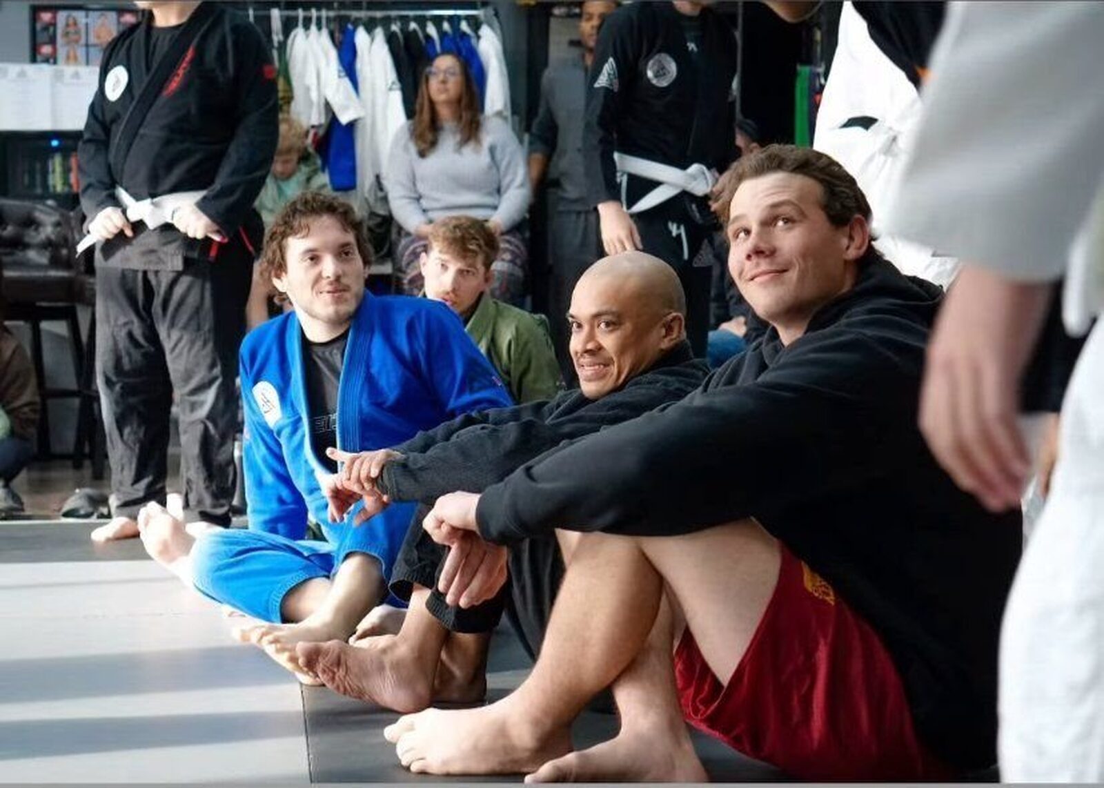 Students laughing together on the mats