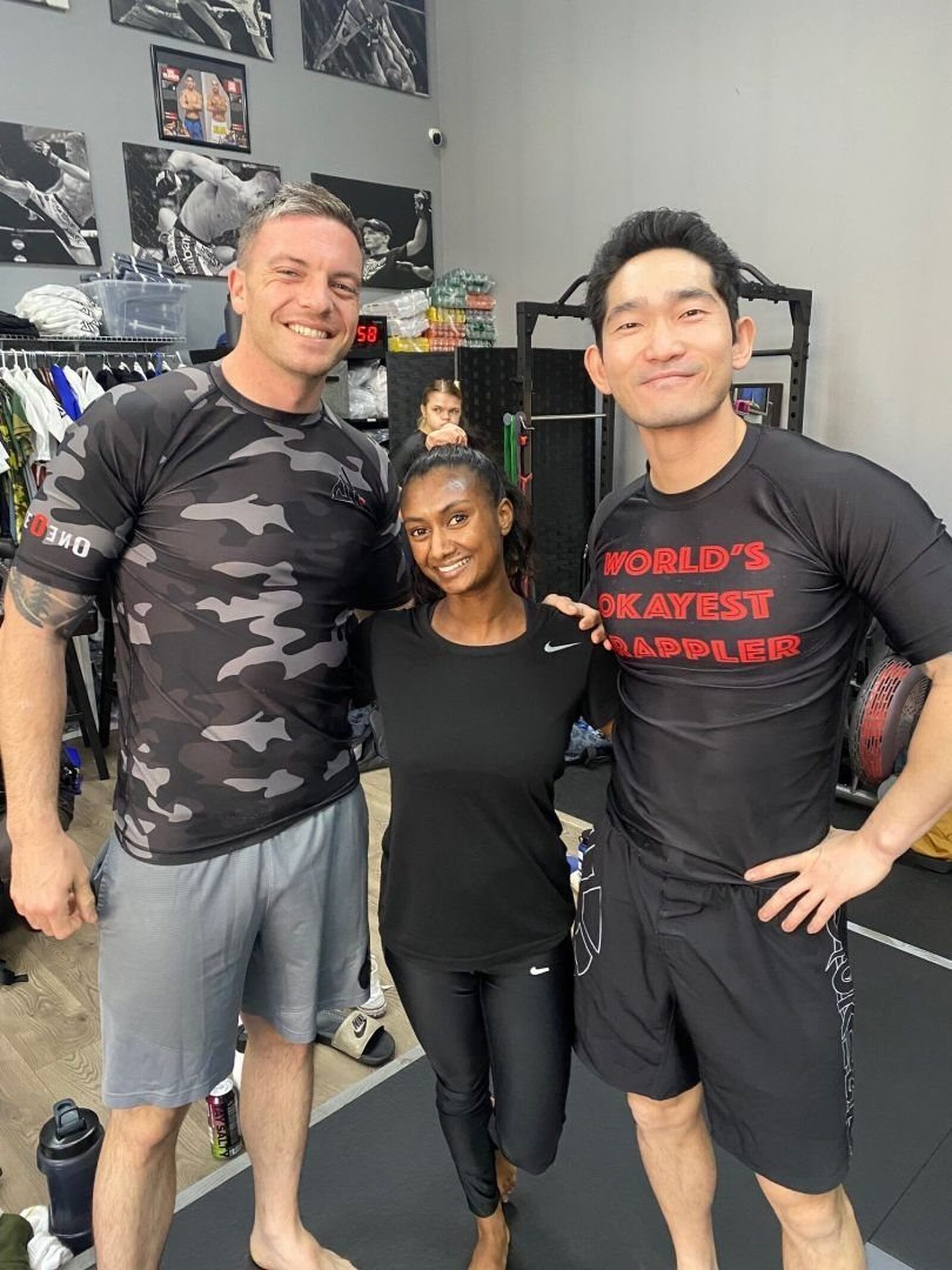 Three training partners smiling after class