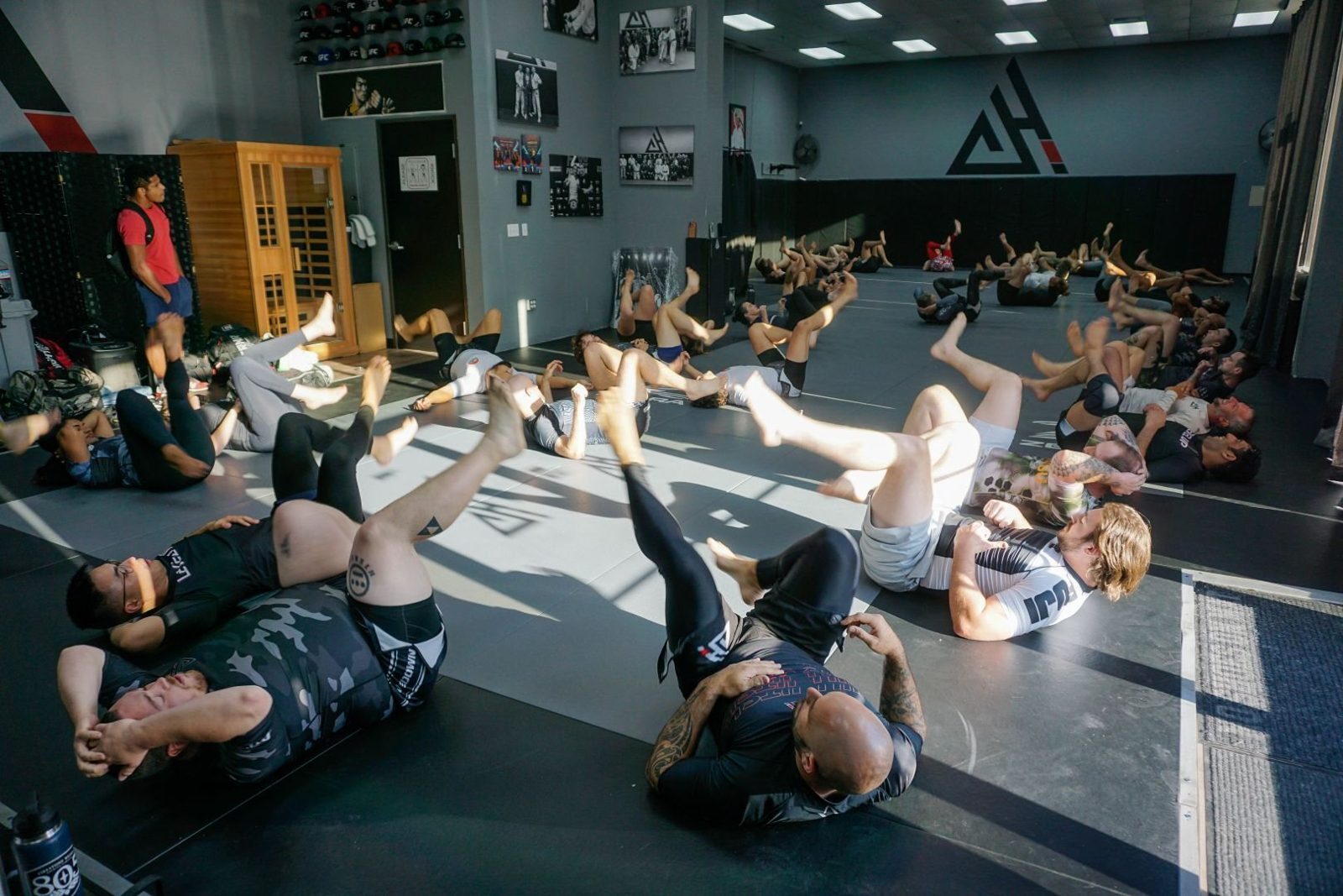 A full adult class warming up on the mats at Holdsworth Jiu Jitsu in Orangevale