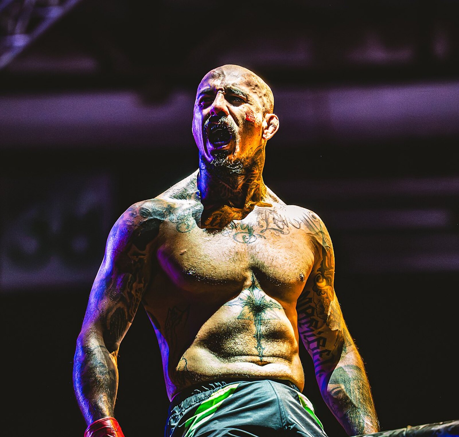 Head coach Ricky 'Savage' Maynez roaring in the cage under purple fight-night lights on CFC 7 night in El Paso