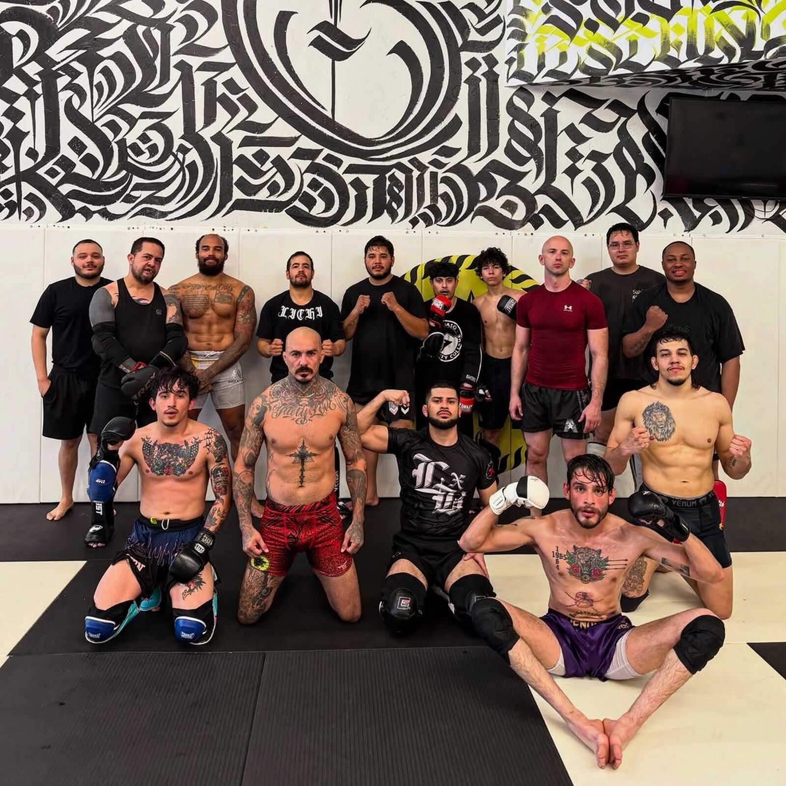 SVG fight team group photo on the gym mats after training, everyone smiling