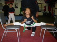 One of our girls doing the splits between 2 chairs