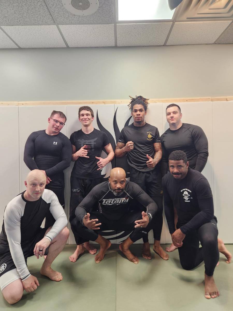 Military and first responders taking a group photo after participating in RPMA Heroes Jiujitsu night